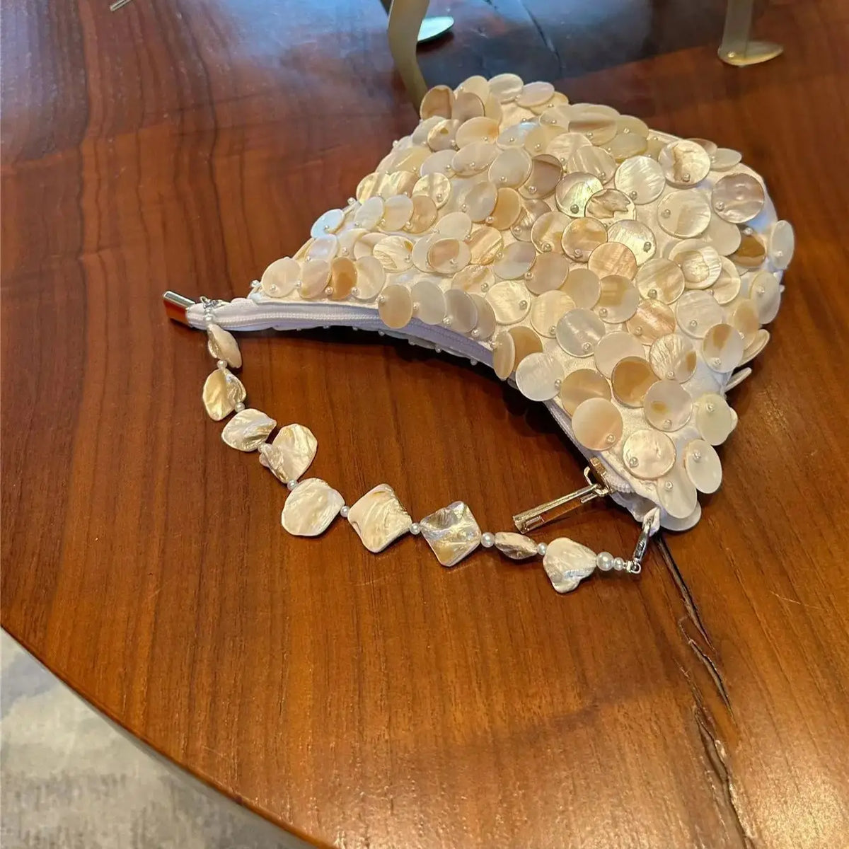 Disc-Embellished Crescent Shoulder Bag